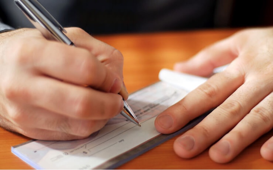 man writing cheque