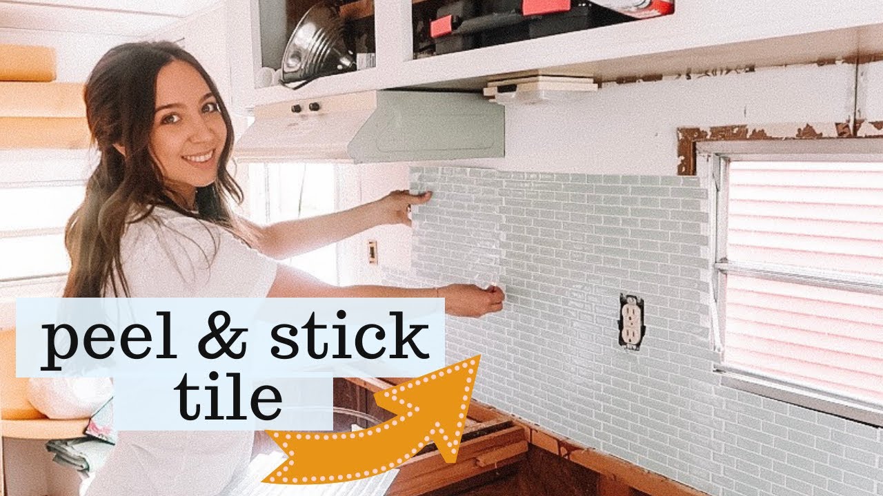 women sticking wallpaper to the RV wall