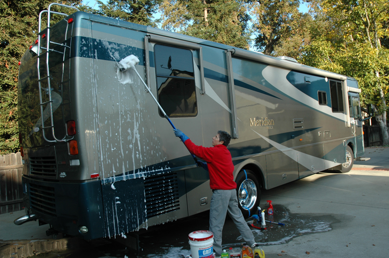 man washing RV