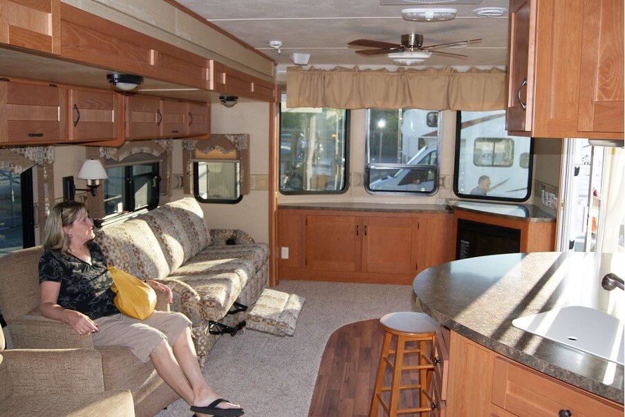 women sitting on sofa inside an RV