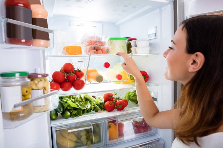 women opening door RV refrigerator