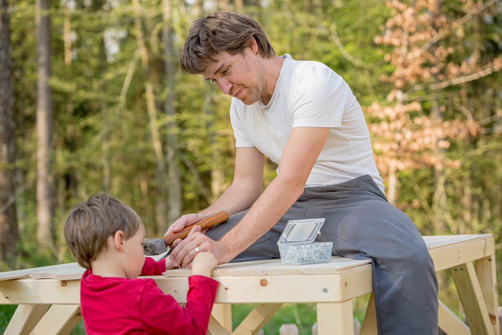 Young,Father,Building,Wooden,Play,House,With,His,Toddler,Son
